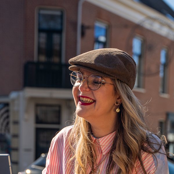Marlies smiling on a sunny terrace in the Netherlands